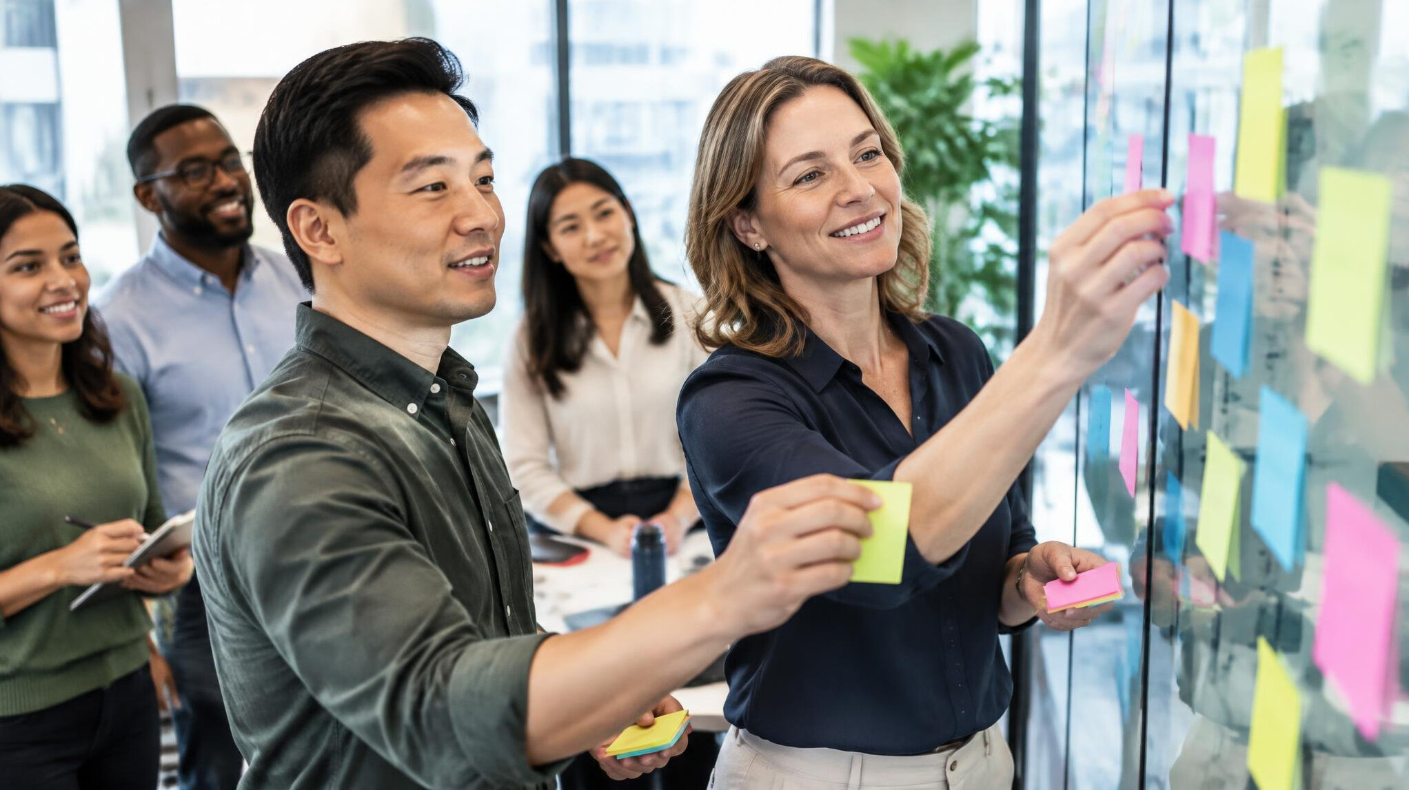 Team workshop with sticky notes on a glass wall